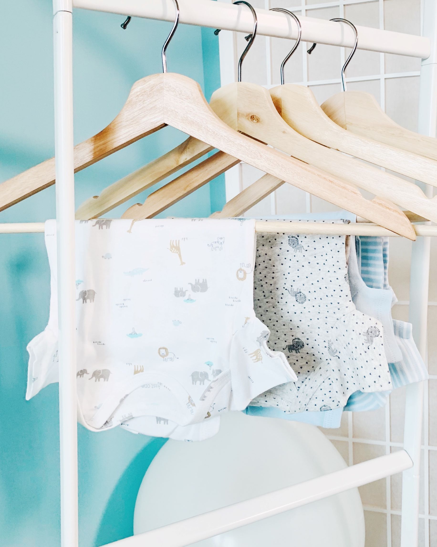 Baby clothes hanging on hangers